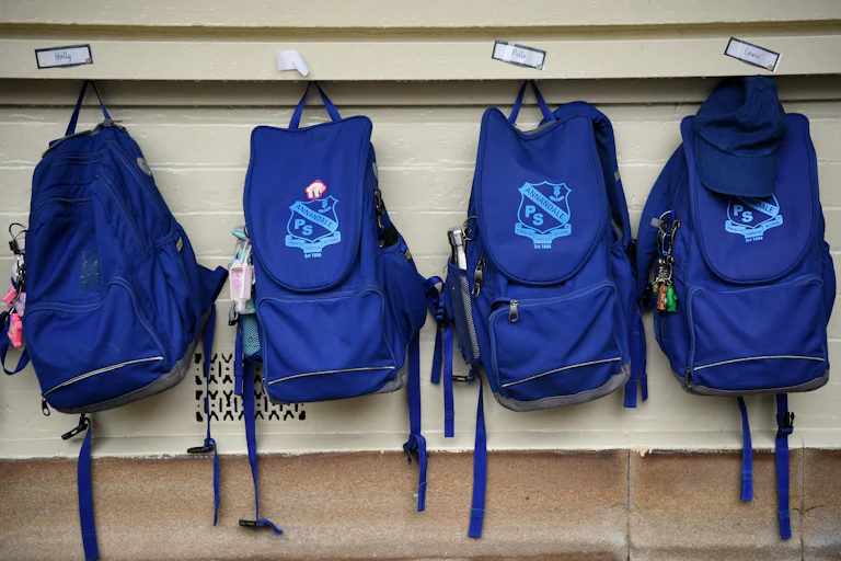 Schools bags hanging up.