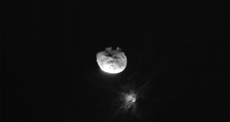 A grayscale rock suspended in air on a dark background