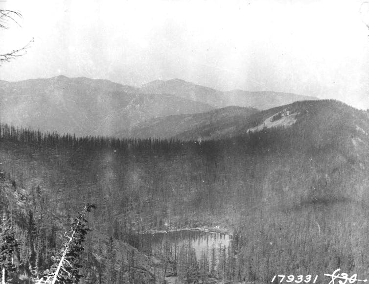 A black and white image of a mountain on fire