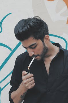 Man lighting cigarette