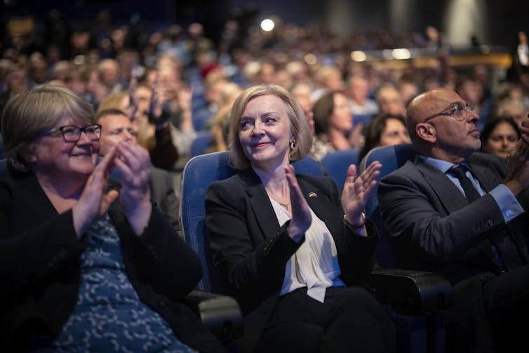 Britain's Prime Minister Liz Truss, centre, at the Conservative Party Conference in Birmingham, October 3 2022, shortly after the government announced it was abandoning the tax-cut plan.