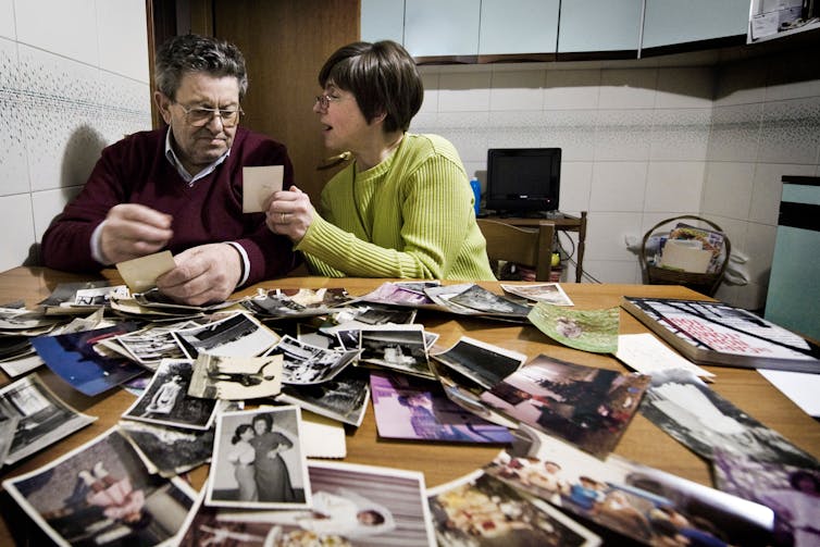 An older couple looking at photographs