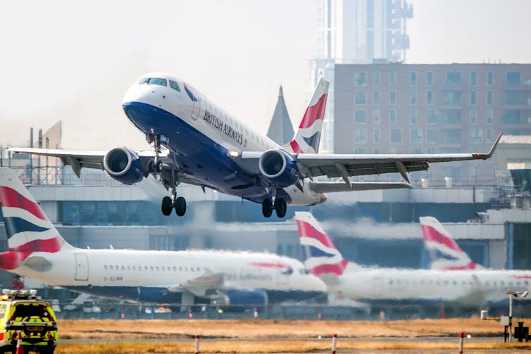 Airplane taking off from the airport runway.