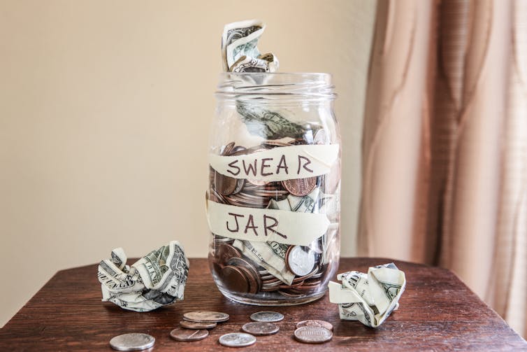 Image of an overfilled swear jar.