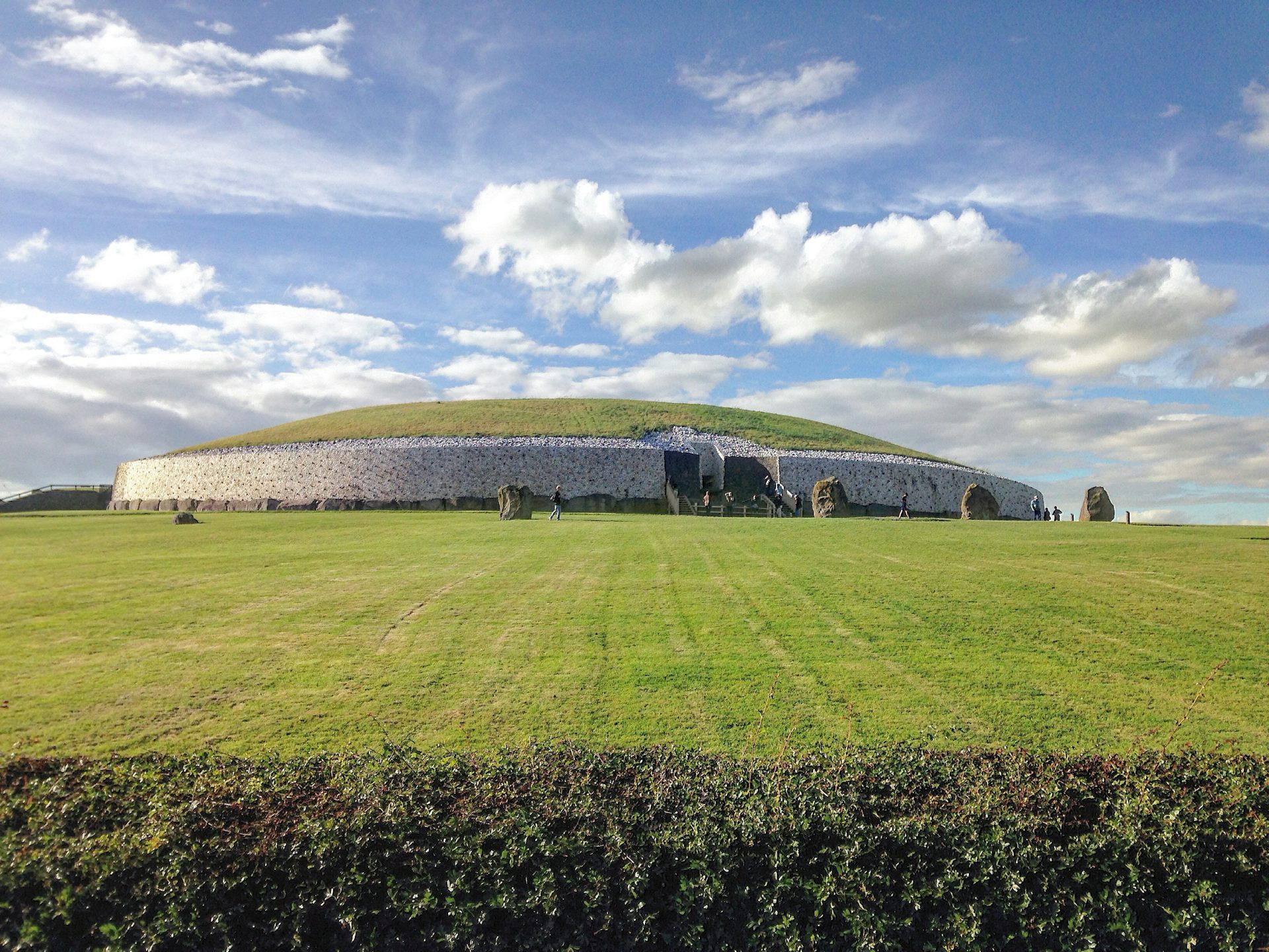 A front view of the Newgrange monument in Ireland taken from outside the grounds.