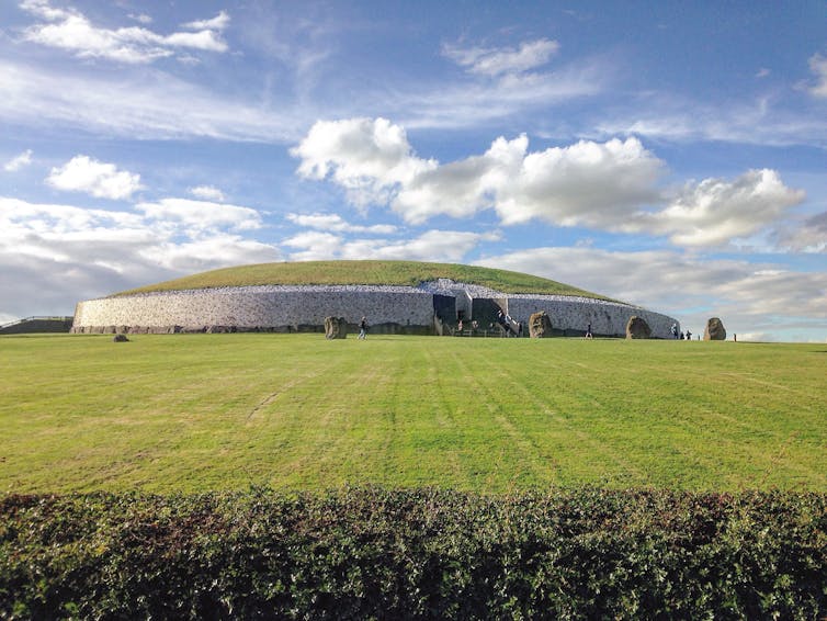 A front view of the Newgrange monument in Ireland taken from outside the grounds.