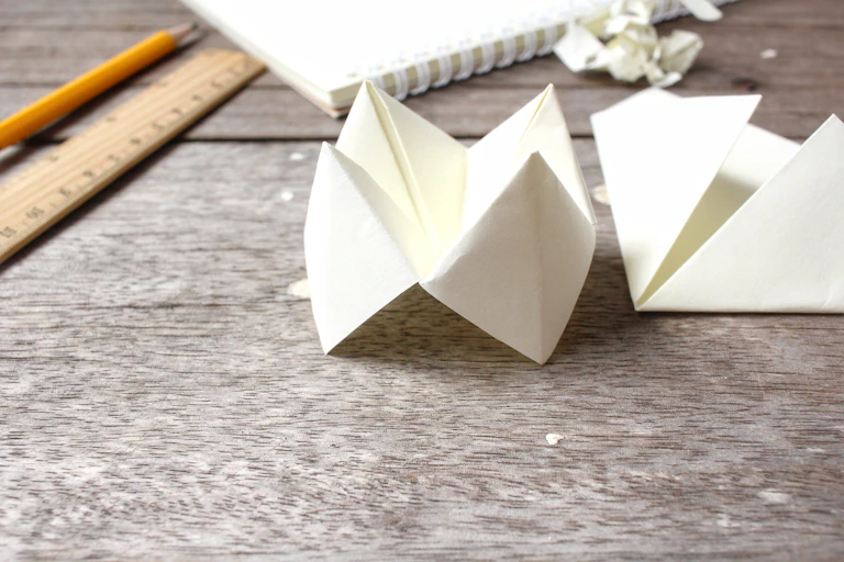 Folded paper seen next to a ruler.