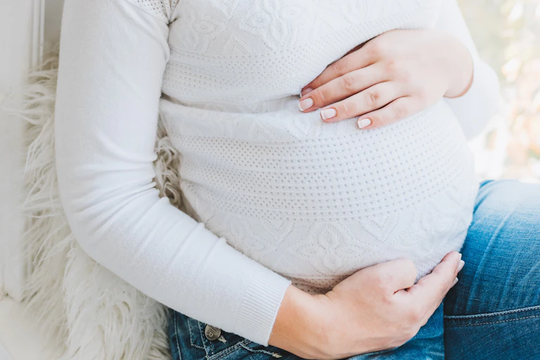 Pregnant woman holding her stomach