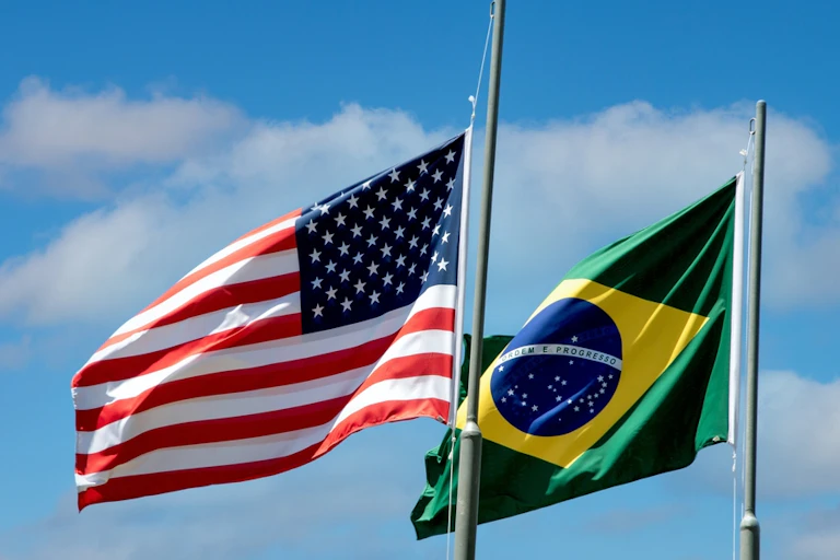 The US and Brazilian flags flying.