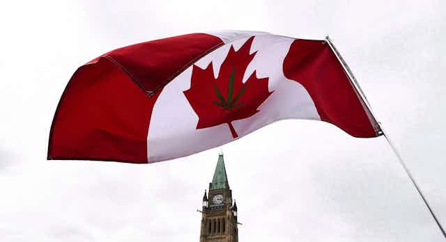 A Canadian flag with a marijuana leaf on it flies above Parliament.