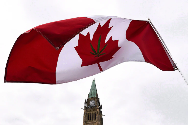 A Canadian flag with a marijuana leaf on it flies above Parliament.