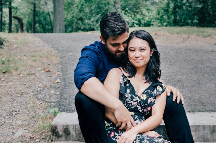 a man and a woman sit together on steps