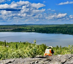 Dr. Xuyang Meng collecting a rock sample in Rouyn-Noranda, Que.