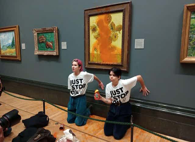 Two protesters in a gallery.