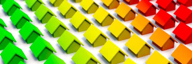 An illustration of rows of houses transitioning from green to yellow and red.