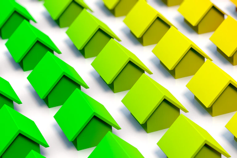 An illustration of rows of houses transitioning from green to yellow and red.