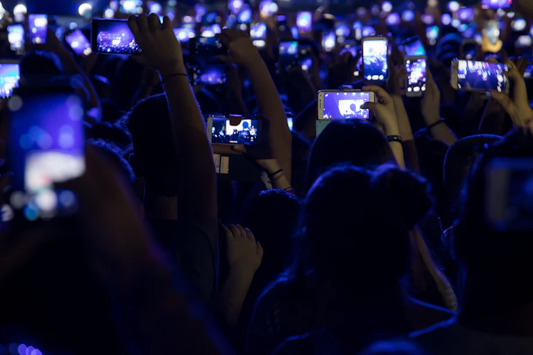Concert crowd holding up phones.