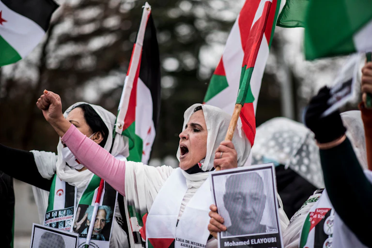 Flag-waving protesters shout slogans