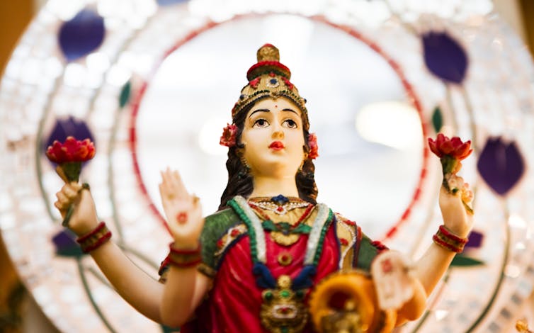 An idol of the Hindu goddess Lakshmi that shows her with four hands.