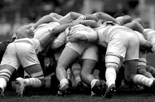 Black and white image of rugby scrum.