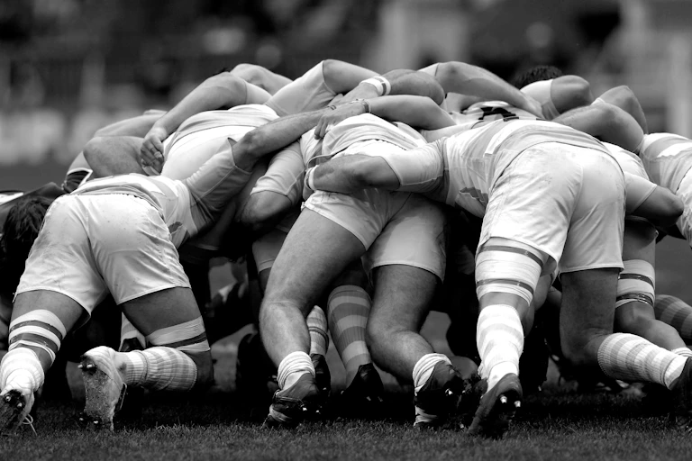Black and white image of rugby scrum.