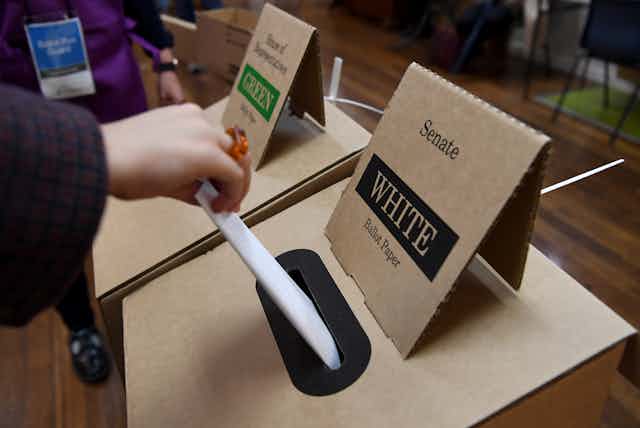 Person voting at the ballot box in the 2022 Australian federal election