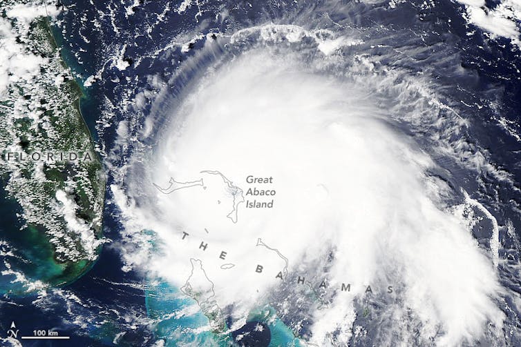 Satellite image of a hurricane over The Bahamas, marked on the map, next to Florida.