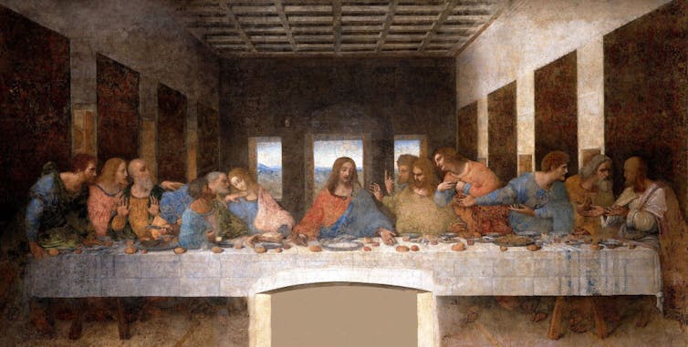 A painting shows thirteen men seated on one side of a long table wearing colored robes