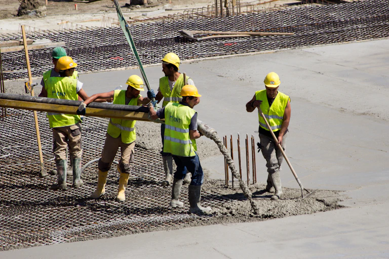 Construction workers pouring concrete