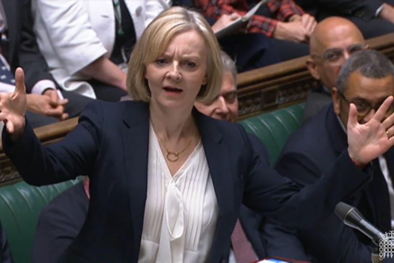 Liz Truss holds up her hands in parliament.
