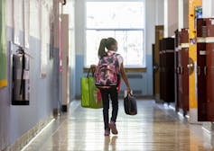 A student seen walking in a hallway