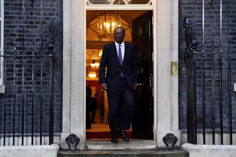 Kwasi Kwarteng walking out of !0. Downing Street.