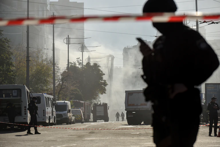 The silhouette of a policeman on a smoke-filled street