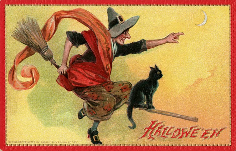 postcard of a witch and a black cat riding a broom