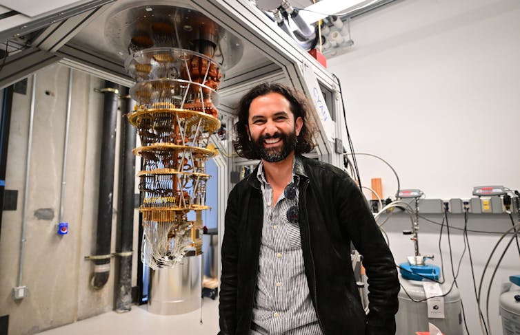 A man stands by a quantum computer in California