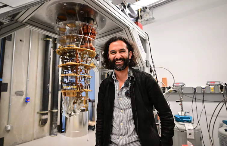 A man stands by a quantum computer in California