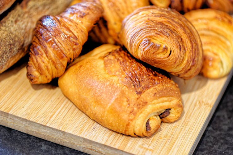 An assortment of buttery pastries, including croissants and pains au chocolat.