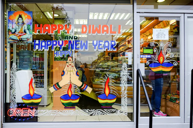 A store front with painted decorations on the window.