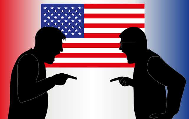 This illustration shows the shadows of two men standing face-to-face and pointing their fingers at each other while standing in front of an American flag.