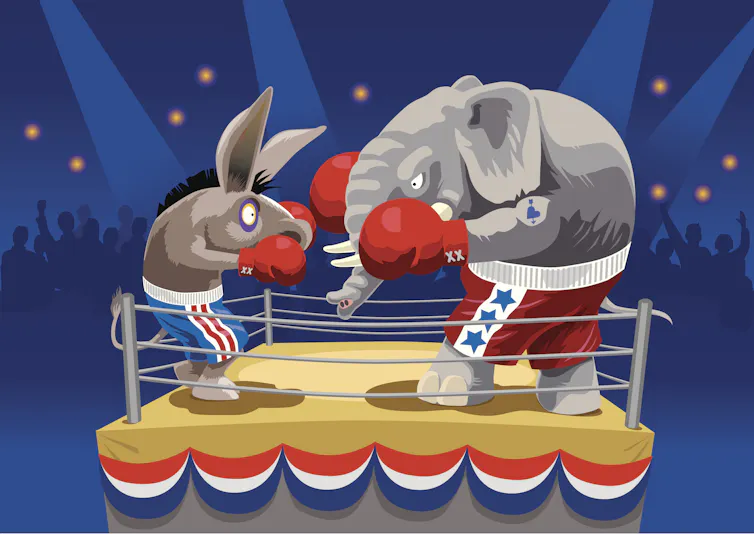 A donkey and an elephant are seen in a boxing ring that is covered with Election Day bunting.