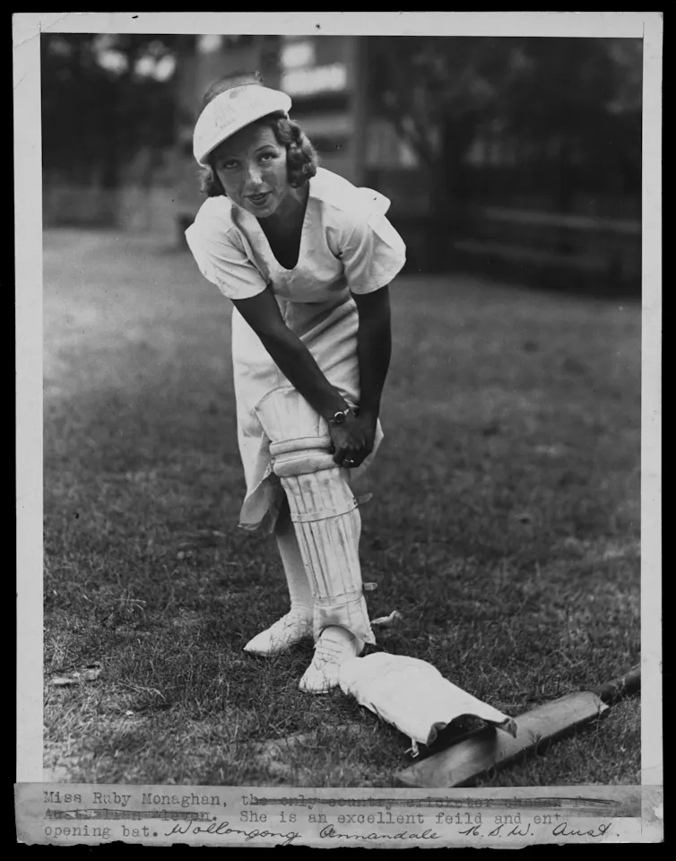 Australian women's cricketer Ruby Monaghan putting on her cricket pads