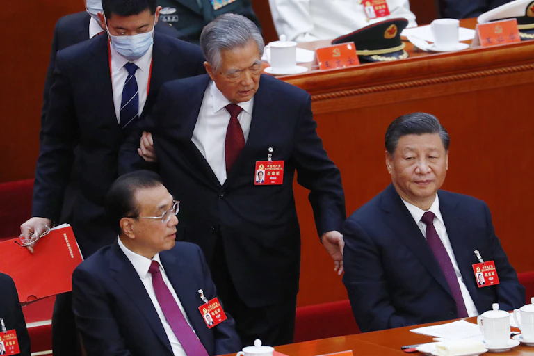 China's former President Hu Jintao (C) is led out by a steward as President Xi Jinping (R) and Premier Li Keqiang (L) look on during the closing ceremony of the 20th National Congress of the Communist Party of China (CPC) at the Great Hall of People in Beijing, China, 22 October 2022.