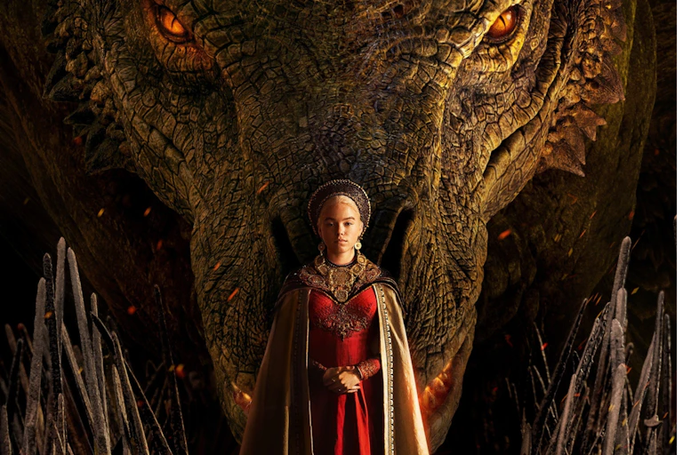 A woman in medieval dress in front of a dragon.
