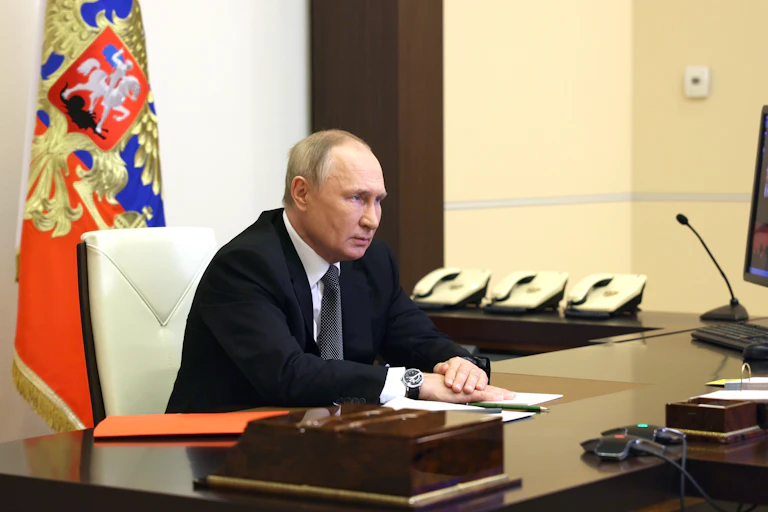 Vladimir Putin sits at his desk talking via video link with members of the Security Council, October 2022.