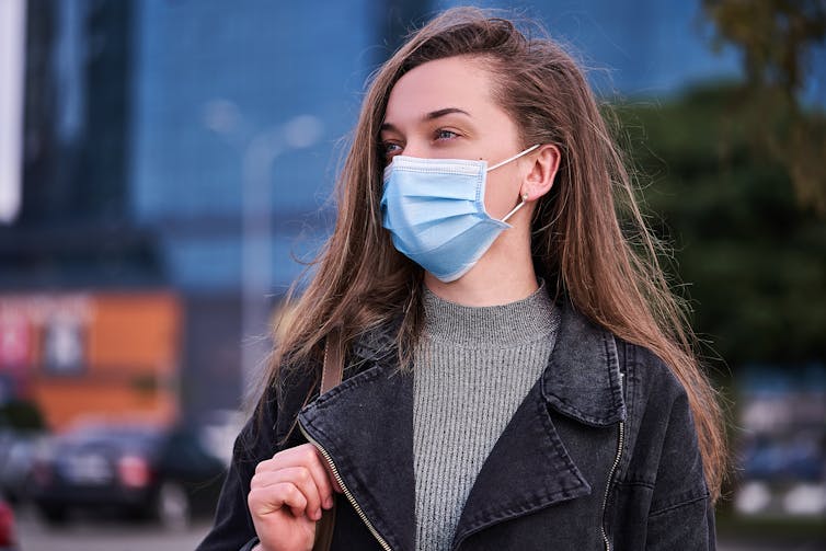 A young woman wearing a mask.