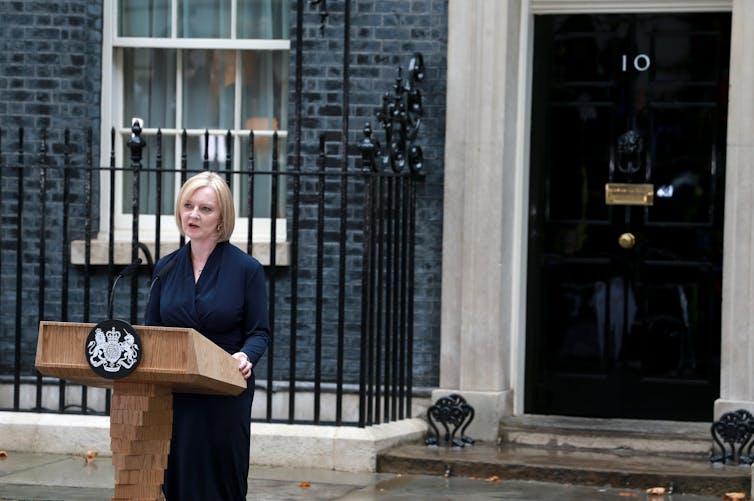 Former prime minister Liz Truss stands at a lectern giving her resignation speech outside Number 10 Downing Street on October 20 2022.
