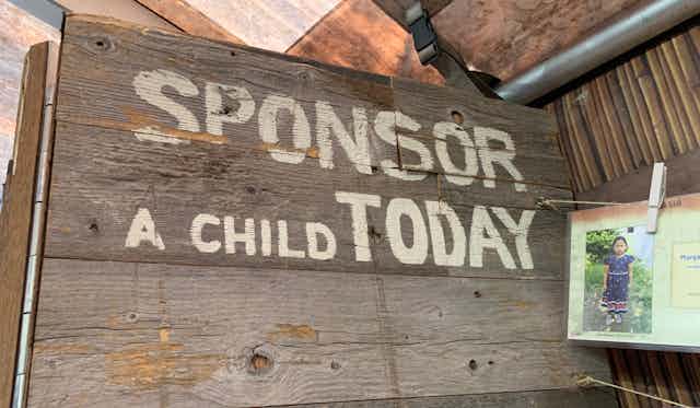 A sign that reads: sponsor a child today.