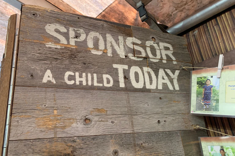 A sign that reads: sponsor a child today.