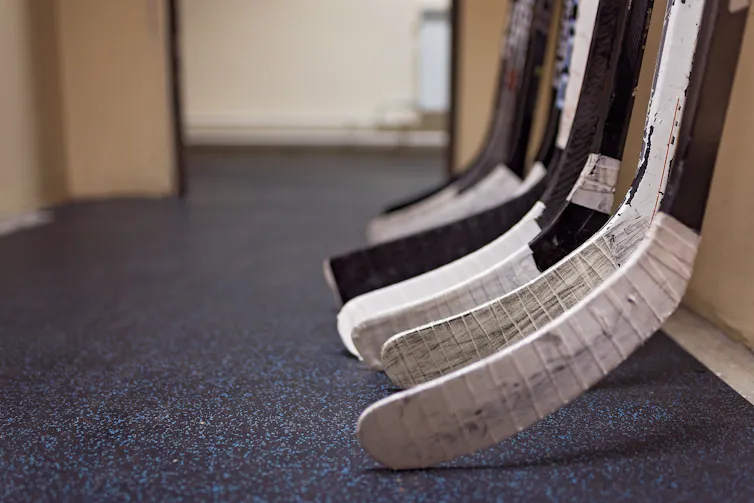 A row of hockey sticks.