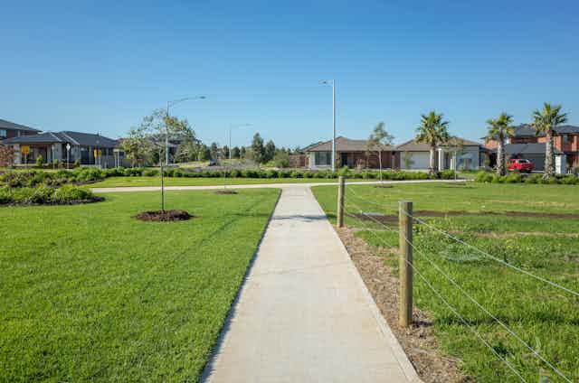 footpath through grass leading to houses